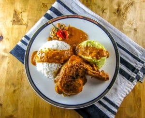 Congo Moambe Chicken served with rice and fufu