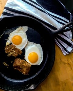 Ohio Goetta frying up in the skillet with sunny side up eggs