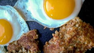 Detail of Goetta frying up in the skillet with eggs
