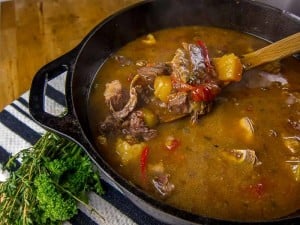 St. Kitts and Nevis Goat Water Stew in a cast iron dutch oven with parsley and thyme garnish