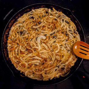 Cronions frying in a skillet
