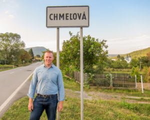 Patrick Jaszewski standing in front of the city sign of Chmelova